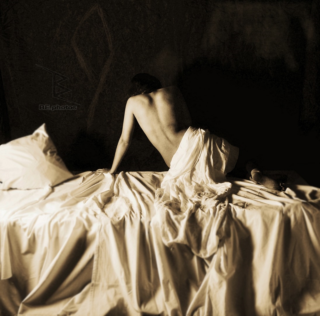 The Woman Who Loved Purple, a sepia-toned student recreation of a woman seated on a bed with white fabric.